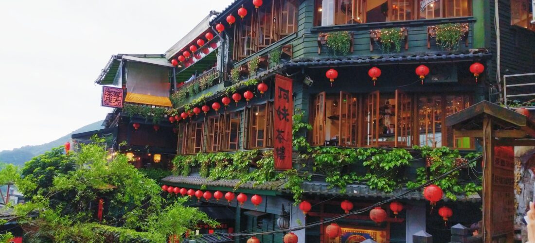 A photo of a back building covered in red lanterns