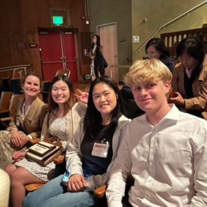 4 students sitting in a row at the Mandarin Speech Contest