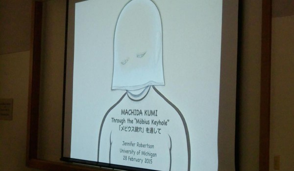 Projector screen displaying "Machida Kumi: Through the "Möbius Keyhole", Jennifer Robertson at University of Michigan