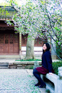 Linshan Jiang fullbody shot in front trees and building